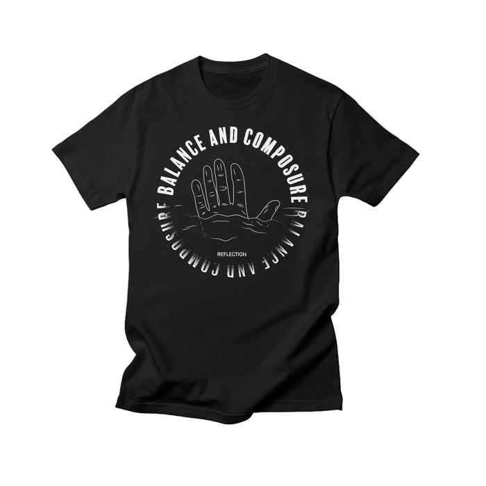 Balance And Composure black Comfort Colors T-shirt with a white outlined palmistry hand on the front, βBALANCE AND COMPOSUREβ encircling it, and βREFLECTIONβ below. Soft fabric ensures everyday comfort.