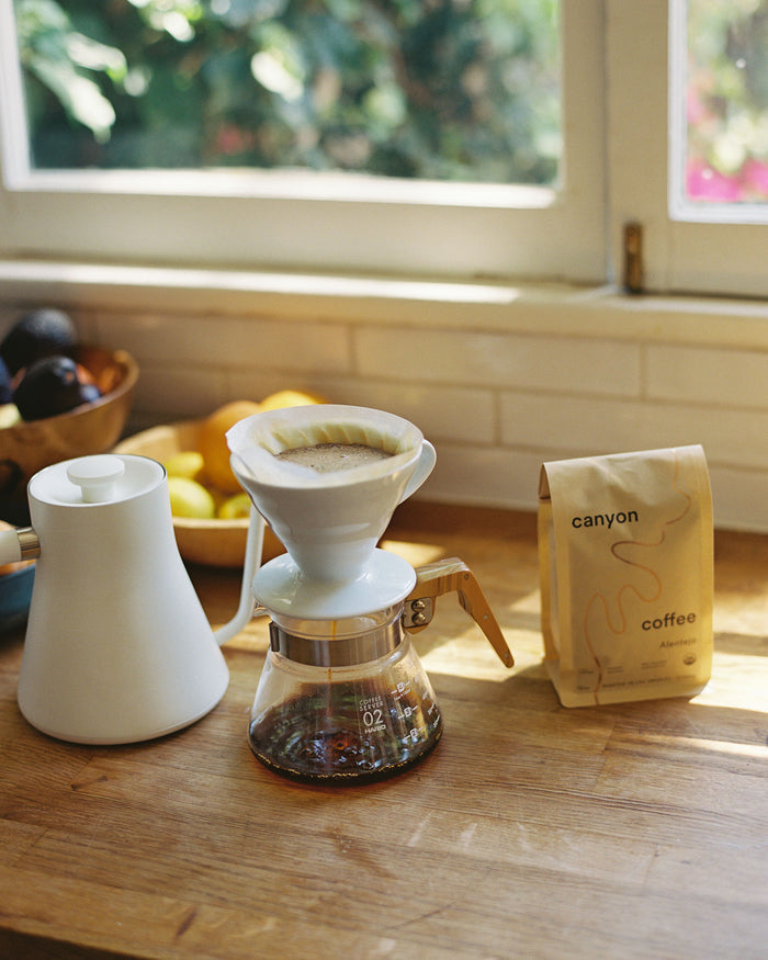White ceramic v60 dipper on glass range server brewing Canyon Coffee