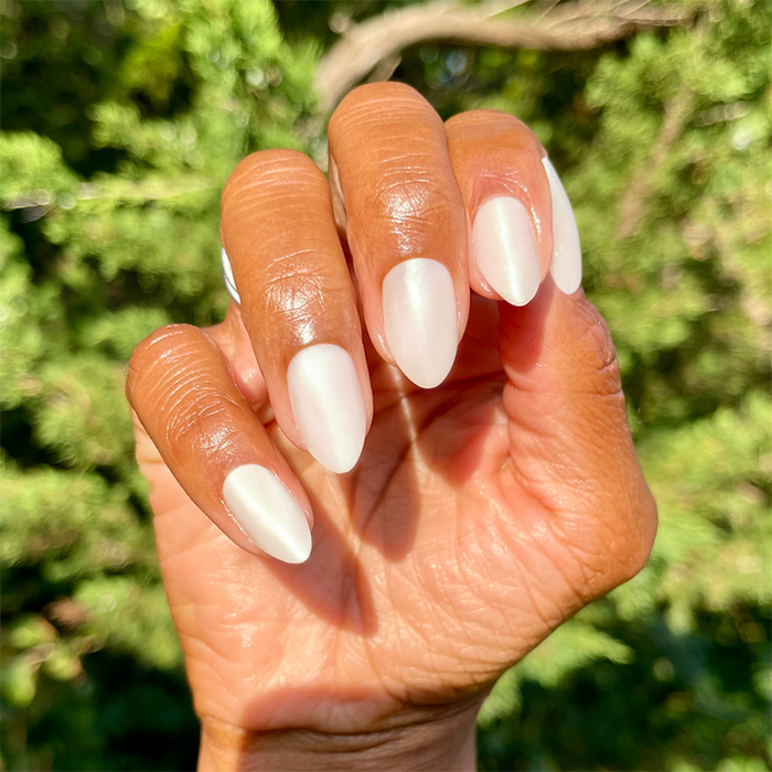 Girl With The Pearl Nail Polish - Press On | Medium | Almond iridescent sheer pearl press-on manicure on hand outdoors