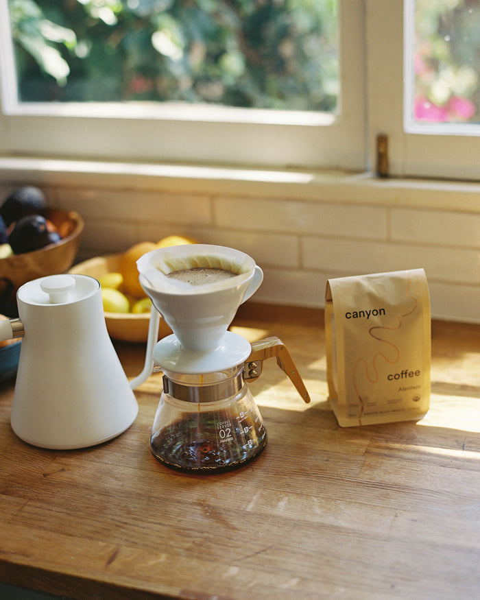 Glass coffee server with wood handle and canyon coffee