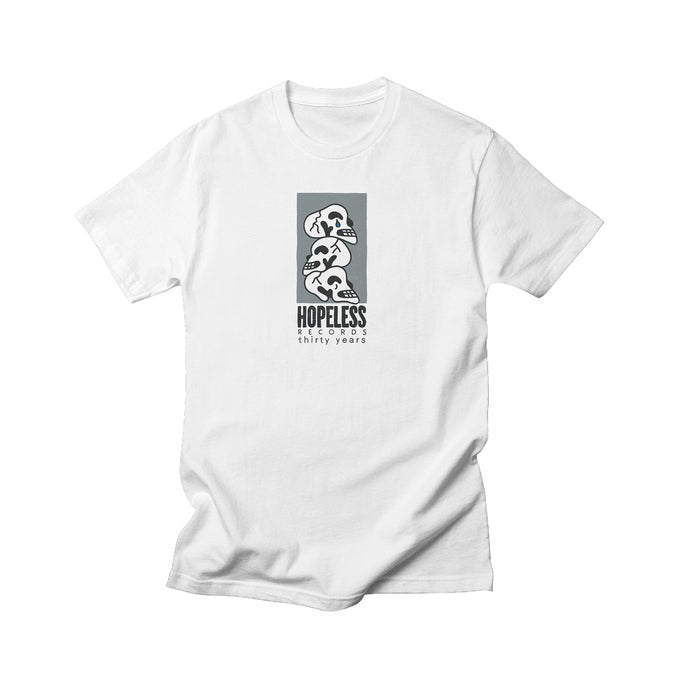 A white Comfort Colors t-shirt from Hopeless Records featuring a modern black and white graphic of three dinosaur skulls stacked above HOPELESS thirty years. Minimalist designβideal for unique apparel enthusiasts.