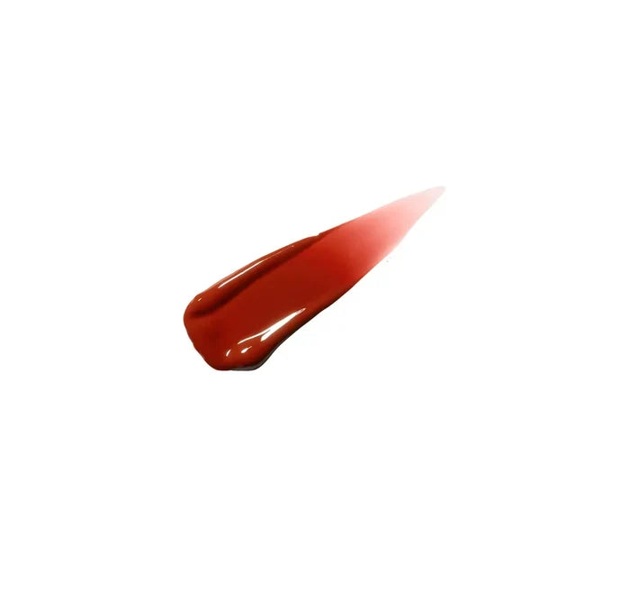 M·A·C Shot of Colour Lip Oil swatch showing vibrant, glossy coral-orange shade on hand for beauty and lip color.