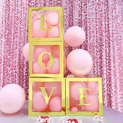 Gold and pink love blocks with balloons on a sparkling backdrop.