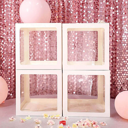 Decorative white display boxes on a pink sequin backdrop.