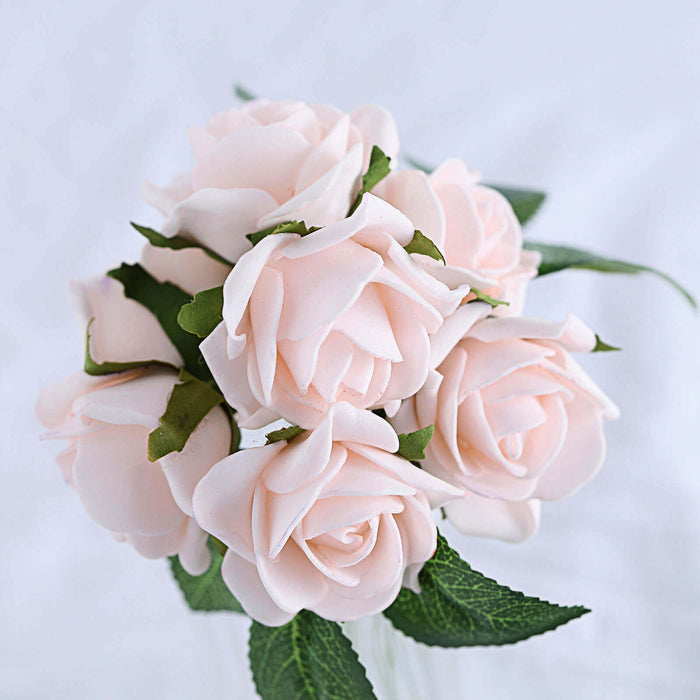 Pink rose bouquet with green leaves on a white background.