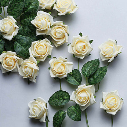 Artificial white roses with green leaves on a light background.
