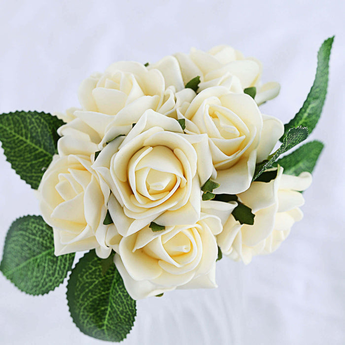 Artificial white roses bouquet with green leaves in a glass vase.