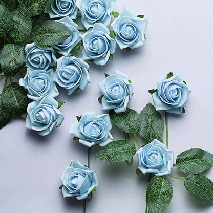 Blue artificial roses with green leaves on a white background.