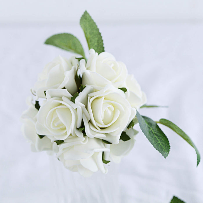 White artificial roses bouquet with green leaves on a white background.