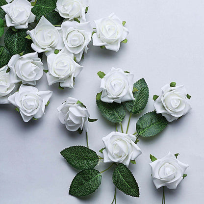Artificial white roses with green leaves arranged on a white background.