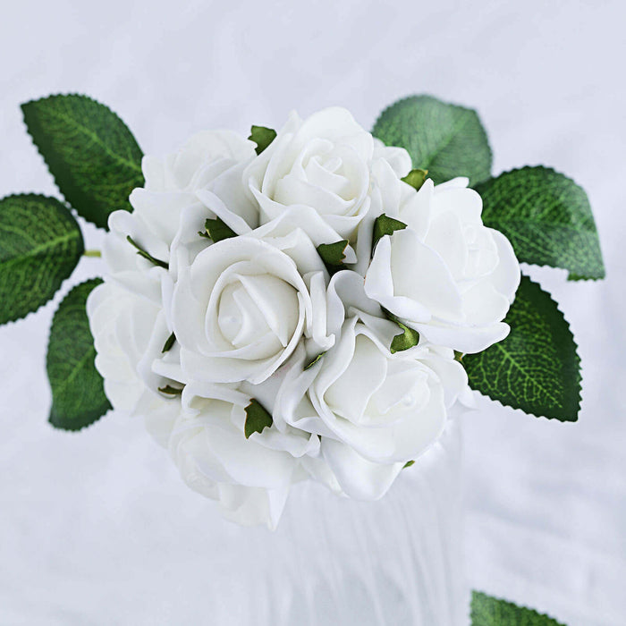 Artificial white rose bouquet with green leaves on a plain background