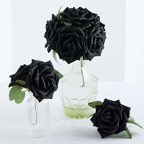 Black artificial roses in glass vases on a white background