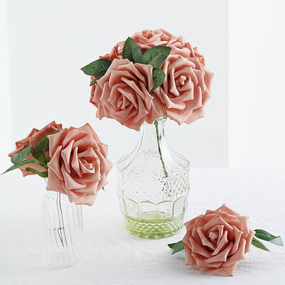 Peach artificial roses in glass vases on a white background.