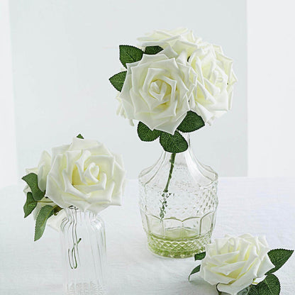 White artificial roses in glass vases on a light background
