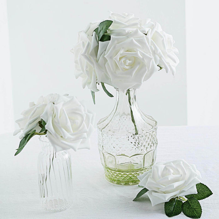 White rose bouquet in glass vases on a light background.