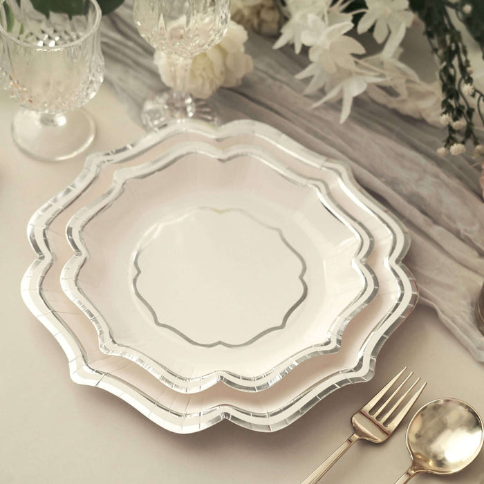 Elegant scalloped disposable plates in white with silver trim.