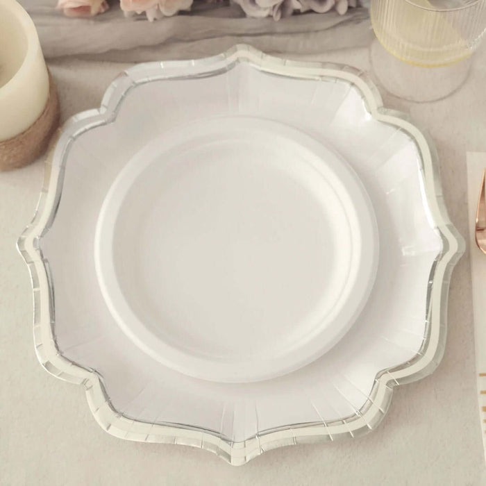 White decorative plate with silver trim on a soft surface