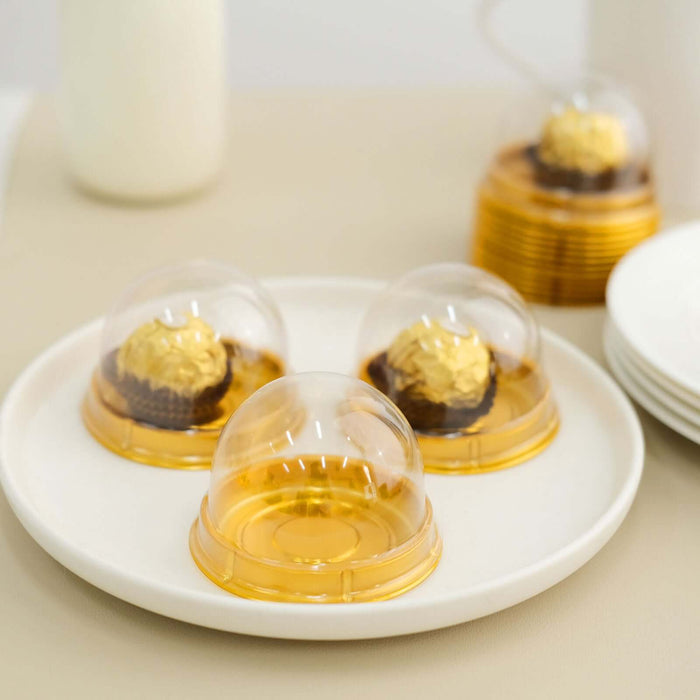 Gold dome dessert cups on a white plate, showcasing delectable treats.