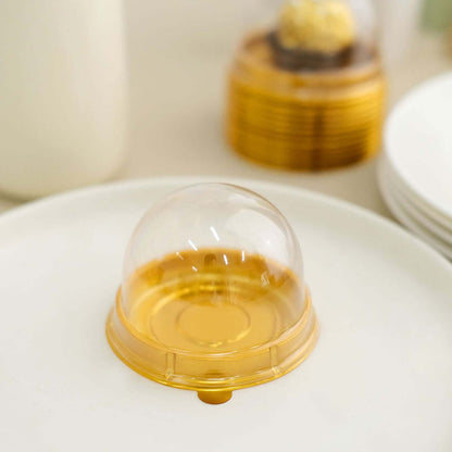 Clear dome lid on a white plate with golden base.