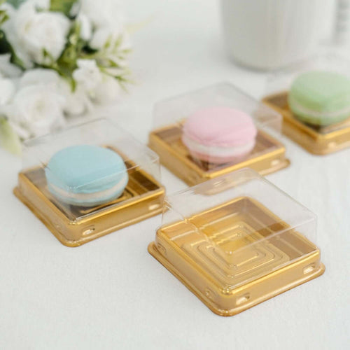Colorful macarons in clear boxes on a white background.