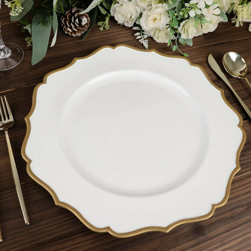 Elegant white plate with gold scalloped edge on a wooden table setting.