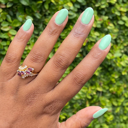 Hand with nails painted in a cool pastel green using Aced It - Gel for a smooth, long-lasting manicure at home
