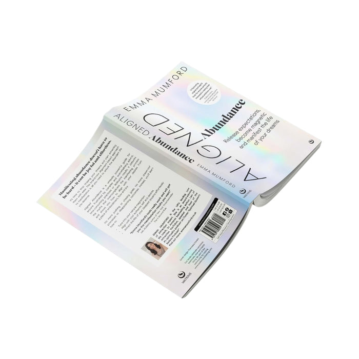 An open book titled 'Aligned' by Emma Mumford, displayed against a solid white background. The book features a white cover with a subtle iridescent rainbow sheen and black typography.
