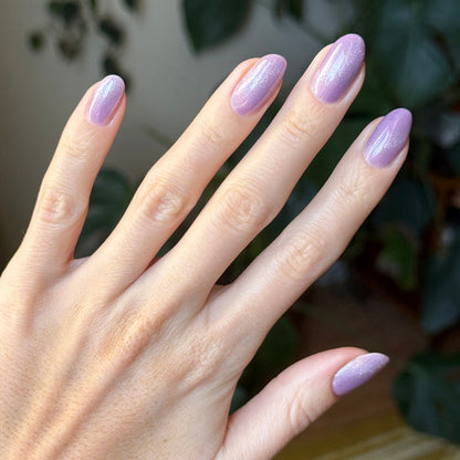 Hand with nails showcasing Amethyst Velvet - Gel pastel lavender magnetic gel polish with subtle shimmer for at home mani