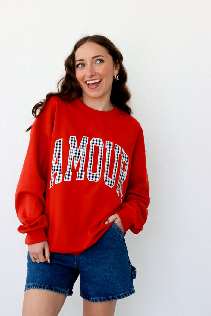 girl wearing red "amour" crewneck