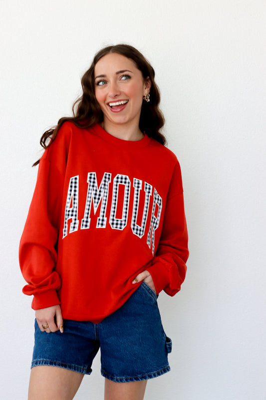 girl wearing red "amour" crewneck