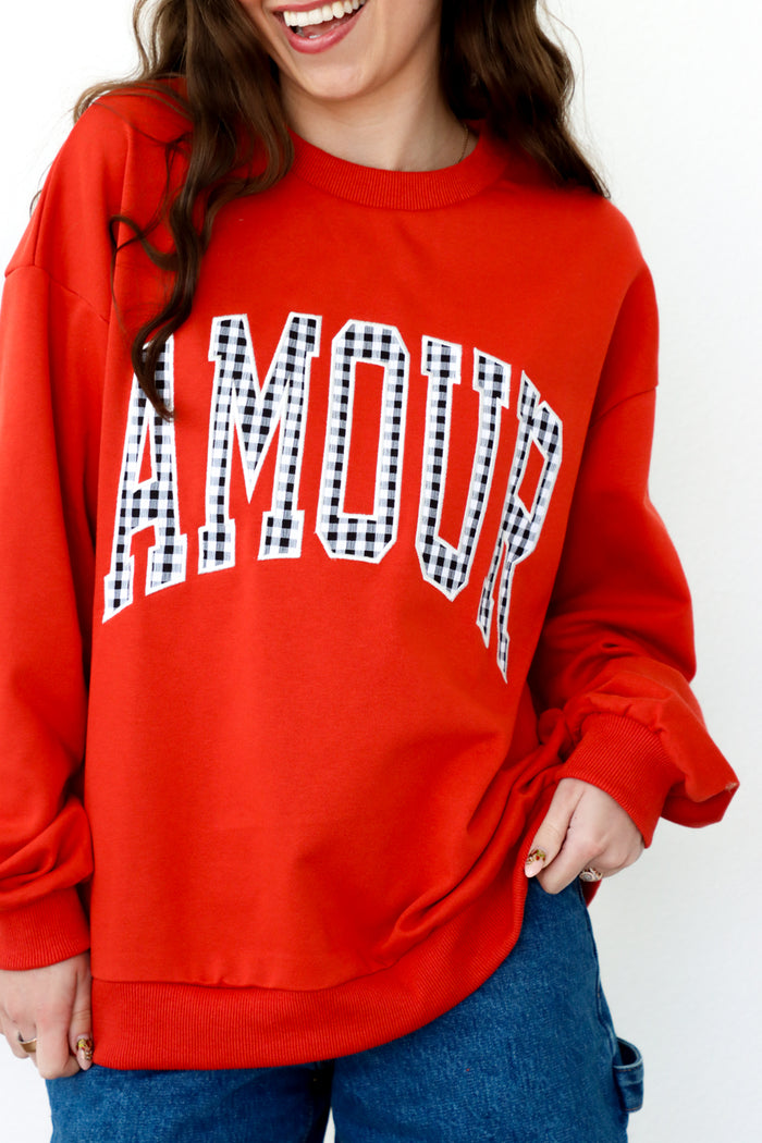 girl wearing red "amour" crewneck