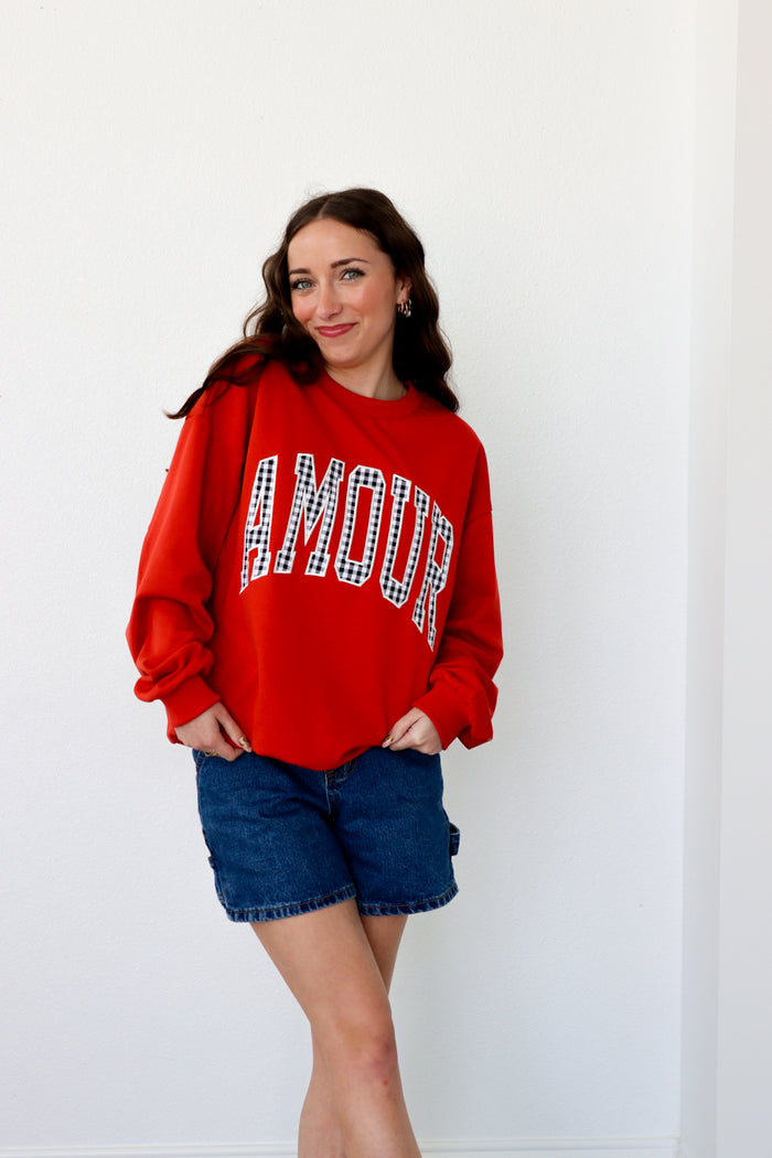 girl wearing red "amour" crewneck