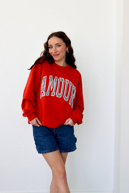 girl wearing red "amour" crewneck