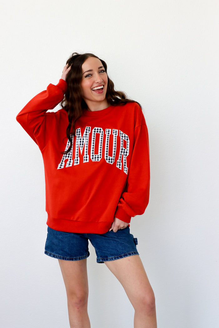 girl wearing red "amour" crewneck