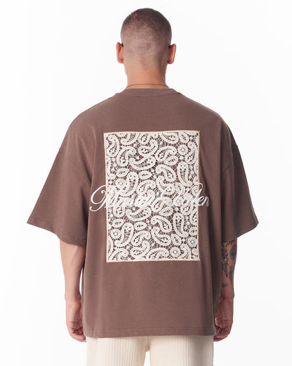 Martin Valen brown T‑shirt front view with small lace applique pocket at chest, close‑up showing texture