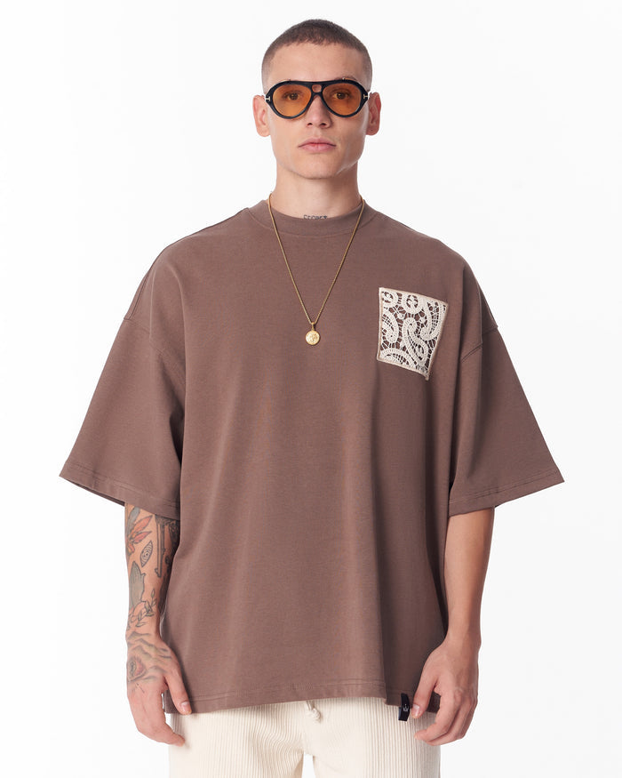 Martin Valen brown T-shirt back view showing a large beige lace appliqué square centered on the back