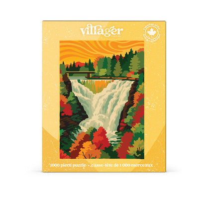 Autumn Cascade | 1,000 Piece Jigsaw Puzzle by Villager Puzzles features an illustrated scene of Kakabeka Falls, with a forest and bridge under an orange sky. The box showcases text in English and French, a maple leaf symbol in the top right corner, and stunning autumn foliage inspired by Canadian art.