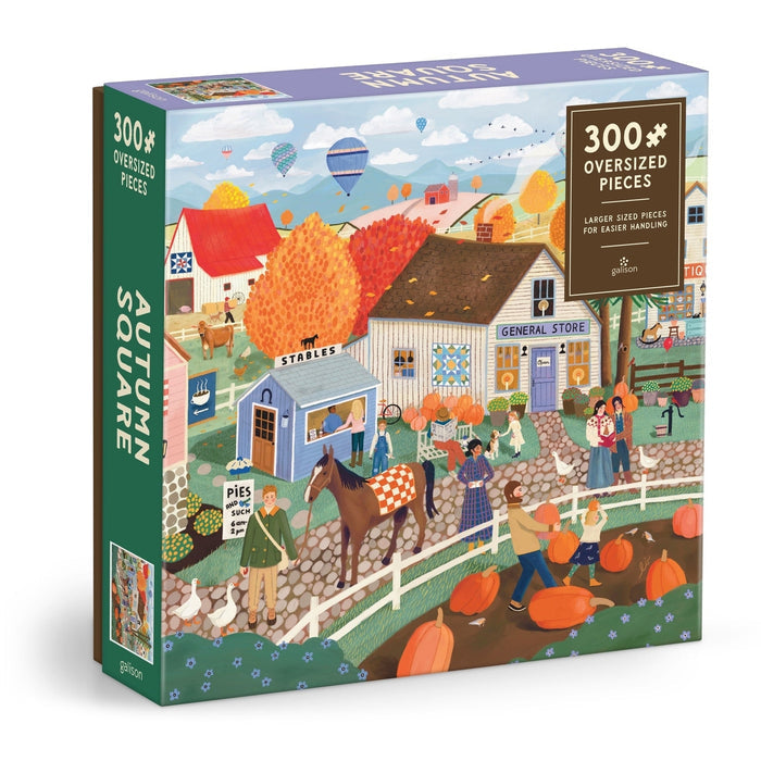 Experience the warmth and beauty of the season with Galison's Autumn Square | 300 Piece Jigsaw Puzzle. This vibrant puzzle features a lively fall village scene filled with people, animals, pumpkins, colorful foliage, and quaint shops—perfect for capturing the charm of autumn.