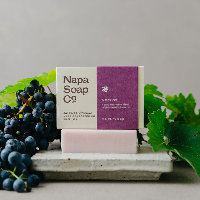Napa Soap Co bar of soap with grapes and leaves on a gray background