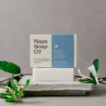 Napa Soap Co. bar soap on a gray background with jasmine greenery