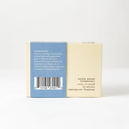 Bar of soap with a blue and white label on a white background