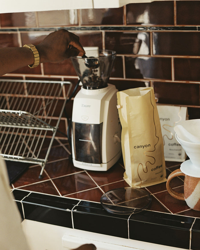 Baratza Encore Burr Grinder with Canyon Coffee in the kitchen with a bag of Alentejo coffee by Canyon
