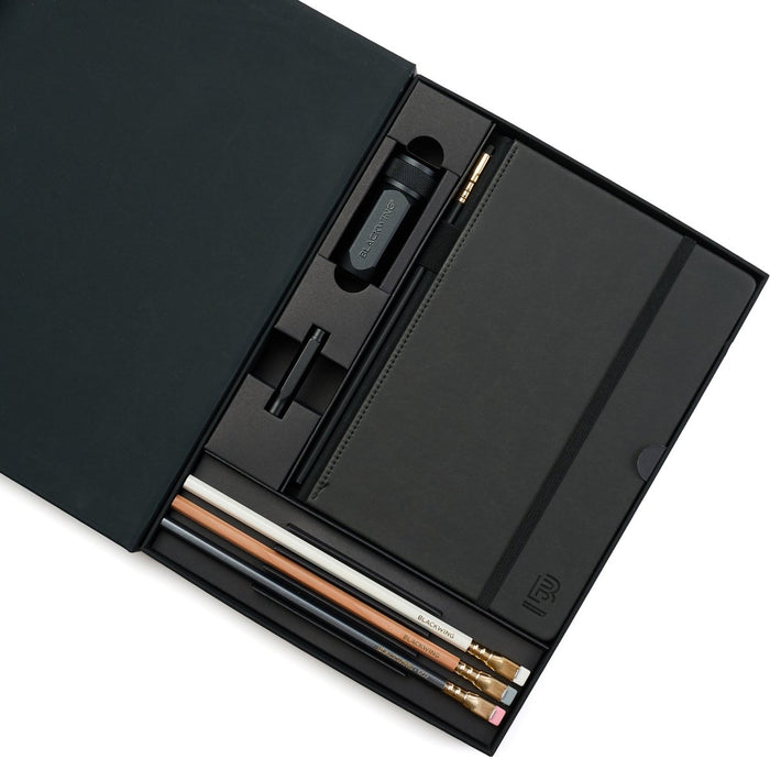 Black stationery set with graphite pencils, notebook, pencil guard, and one-step sharpener.