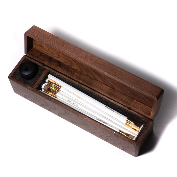 A Blackwing Walnut Box filled with Blackwing pearl pencils and pens.