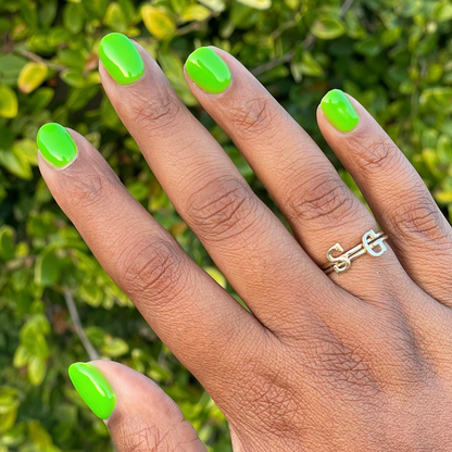 Cancel My Return Flight - Gel bright electric lime gel polish on natural nails with smooth glossy finish and gold initial ring