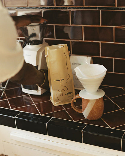 White ceramic v60 dipper on a handmade ceramic mug brewing Canyon Coffee