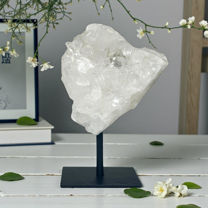 Clear Quartz Cluster on Stand with a blurred background