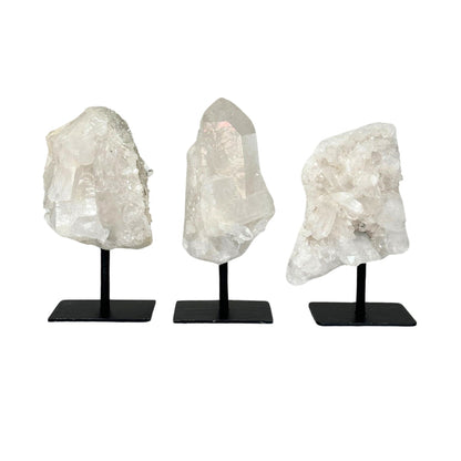 Clear Quartz Cluster on stands against a white background