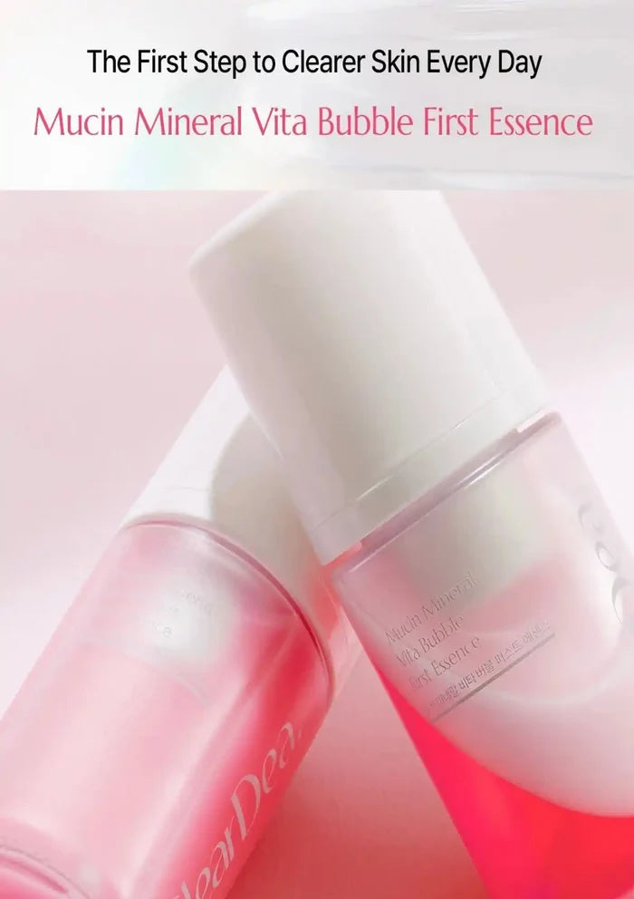 Two pink and white cosmetic bottles labeled 'Mucin Mineral Vita Bubble First Essence' on a soft pink background, with promotional text at the top.