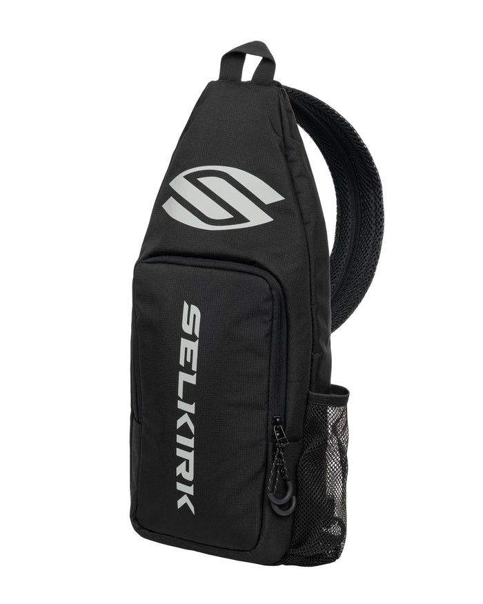 Black Selkirk sling backpack with vertical SELKIRK text, white logo and mesh side pocket